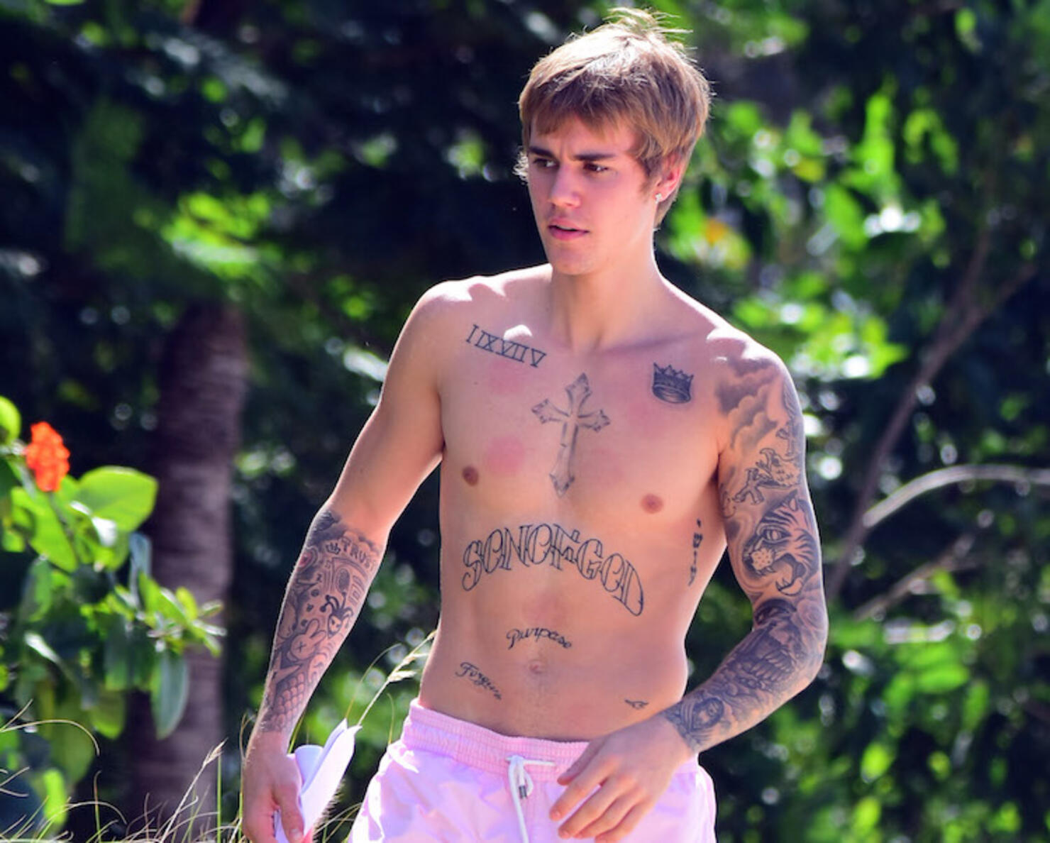 Shirtless Justin Bieber laps up the attention at the beach on Barbados getaway.