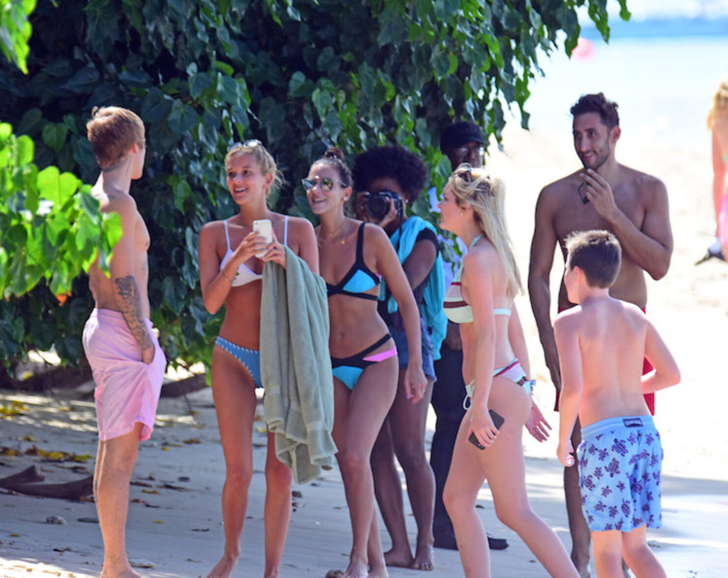 Shirtless Justin Bieber laps up the attention at the beach on Barbados getaway.