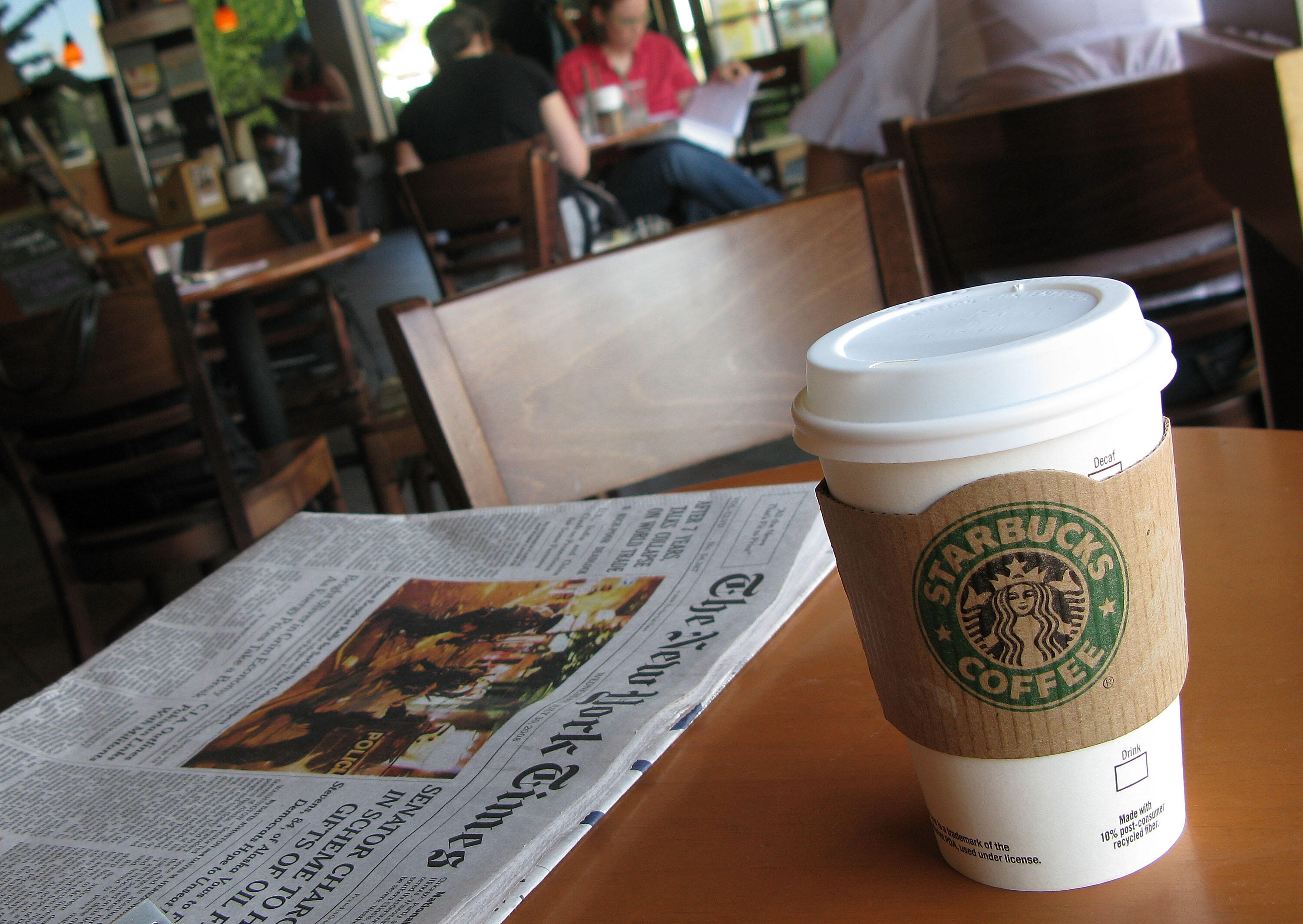 CHICAGO - JULY 30:  Customers sit inside a Starbucks coffee shop July 30, 2008 in Chicago, Illinois. Starbucks Corp. today posted a $6.7 million third-quarter loss and lowered its outlook for the year.  (Photo by Scott Olson/Getty Images)