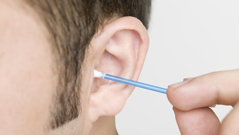 Man cleaning his ear