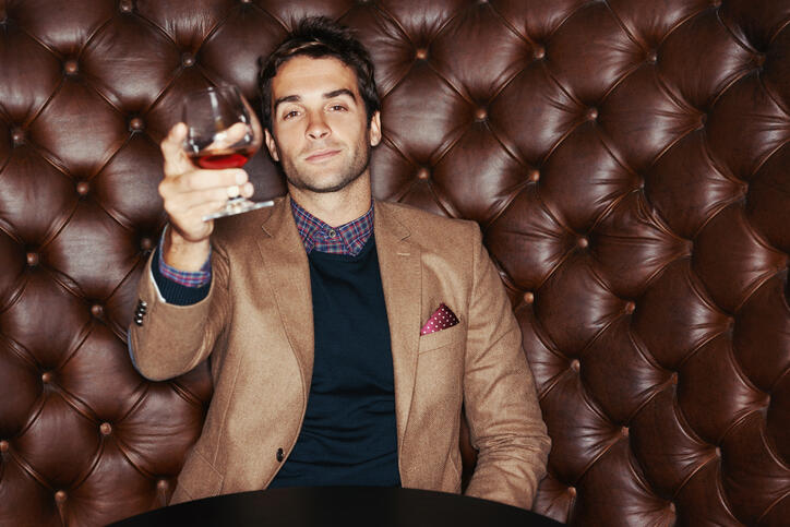 A handsome young man drinking in a club