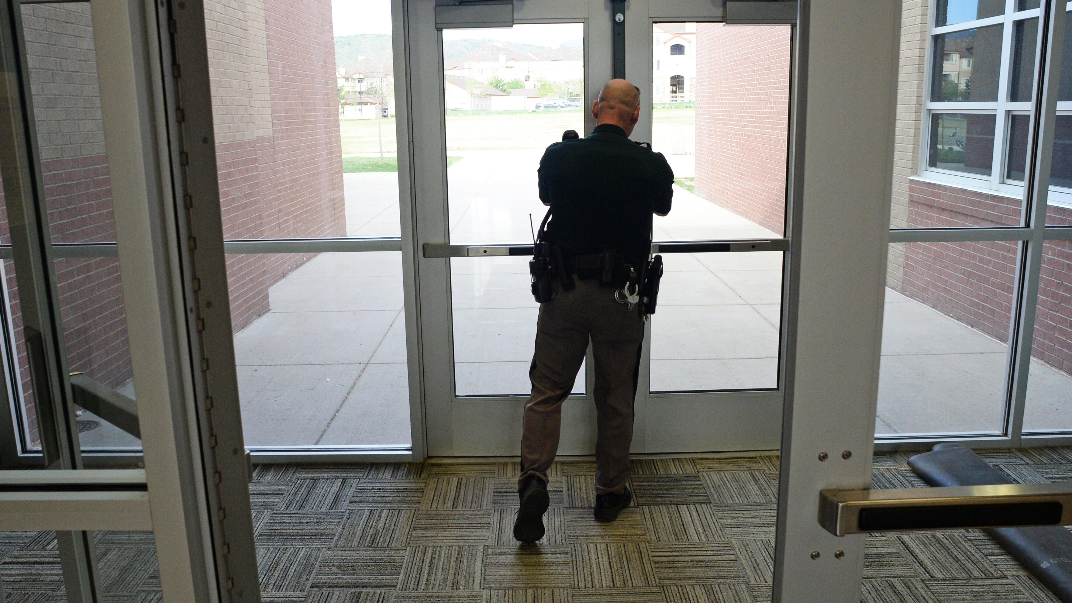 LITTLETON, CO - MAY 06: Deputy Greg Everhart, of the Jefferson County Sheriff's Department, checks to make sure side doors are locked at Falcon Bluffs Middle School in Littleton, May 07, 2014. Everhart, who has been a school resource officer for 11 years,