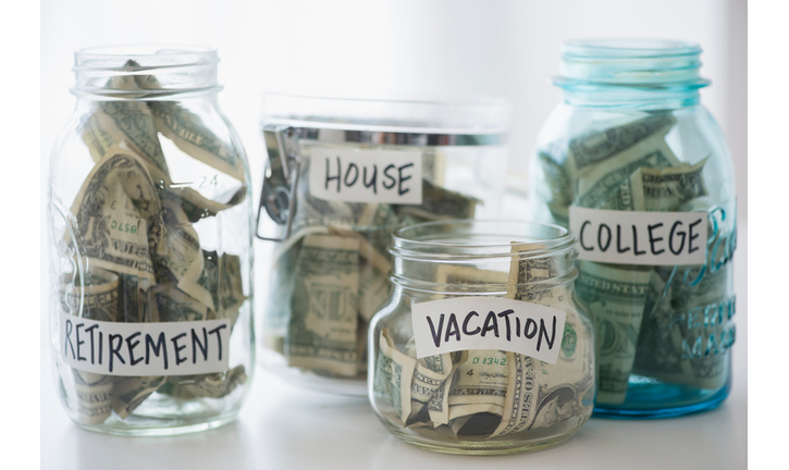 Close up of savings jars with money