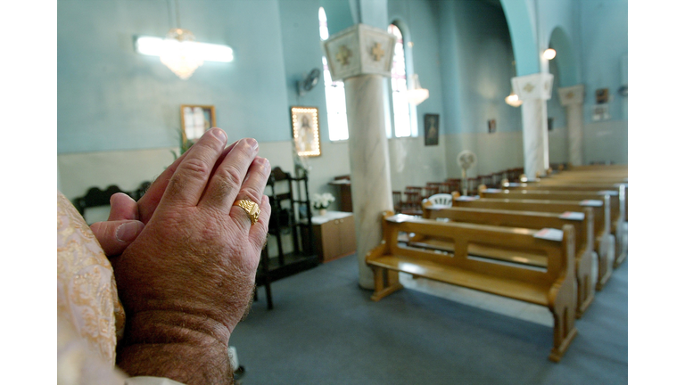 Catholic Priest's Congregation Under Curfew