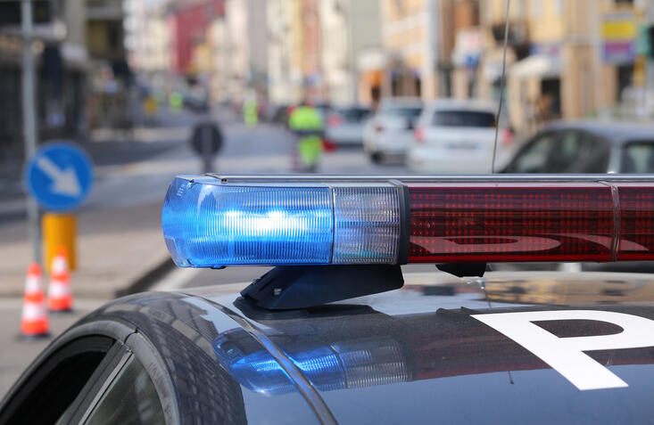 Blue flashing sirens of police car during the roadblock in the city