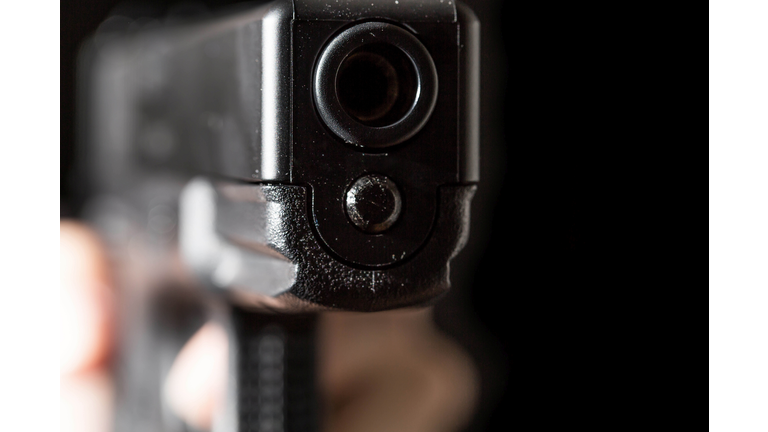Holding a gun on black background