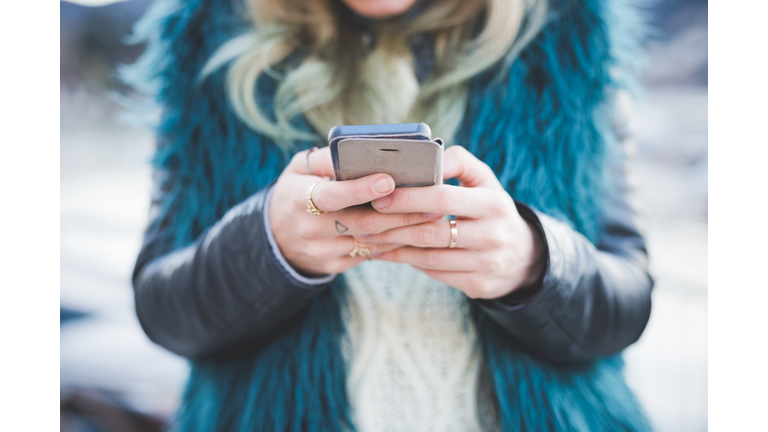 Close up of young woman texting on smartphone, Lake Como, Como, Italy
