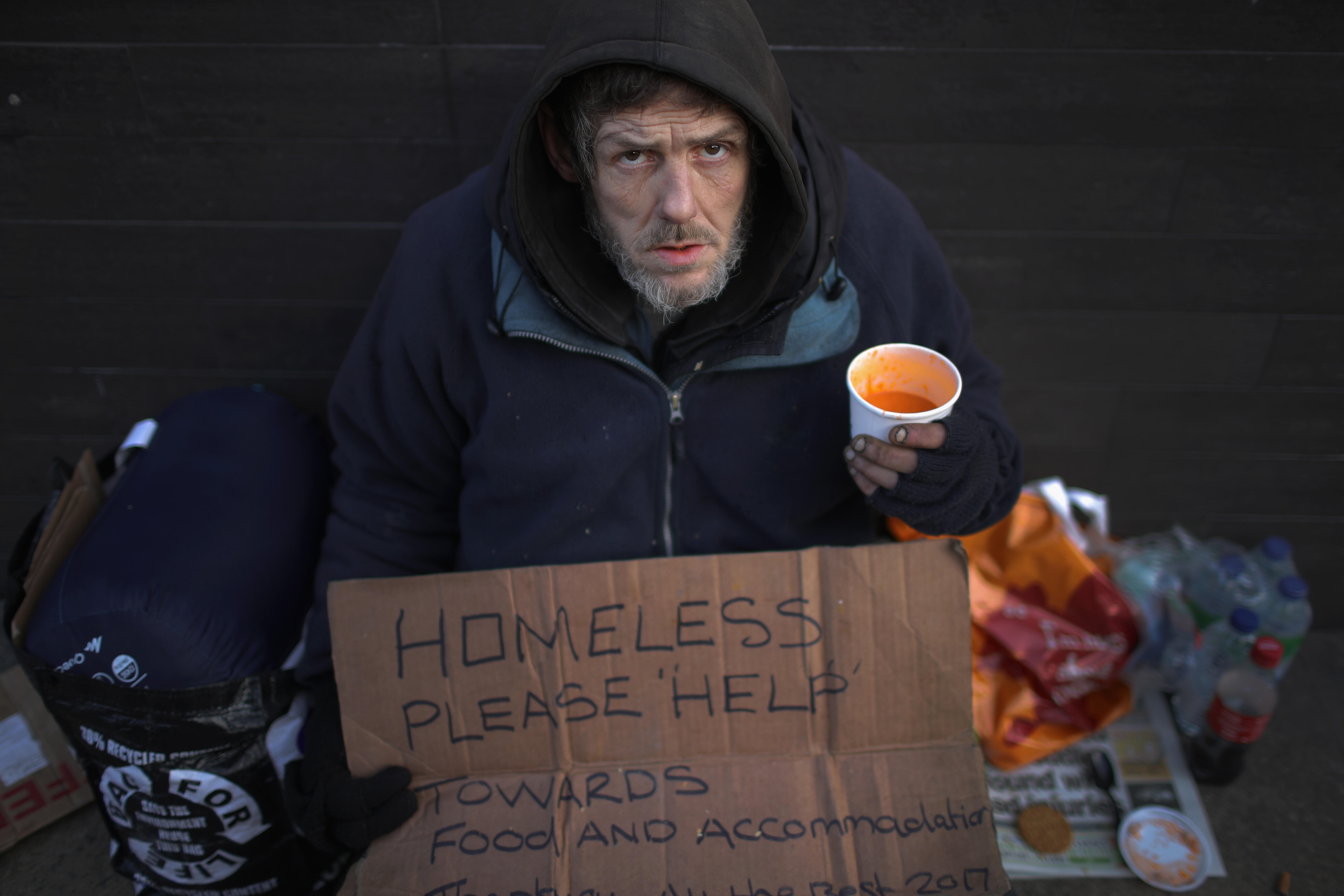 MANCHESTER, ENGLAND - JANUARY 13:  A homeless man begs for small change on the streets of Manchester on January 13, 2017 in Manchester, United Kingdom. Many homeless people are spending the night on the streets in freezing temperatures as the Met Office c