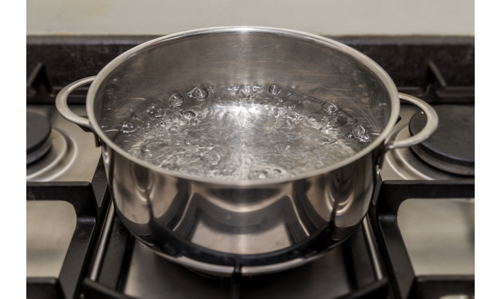 Cookingpan with boiling water on a stove, cooker