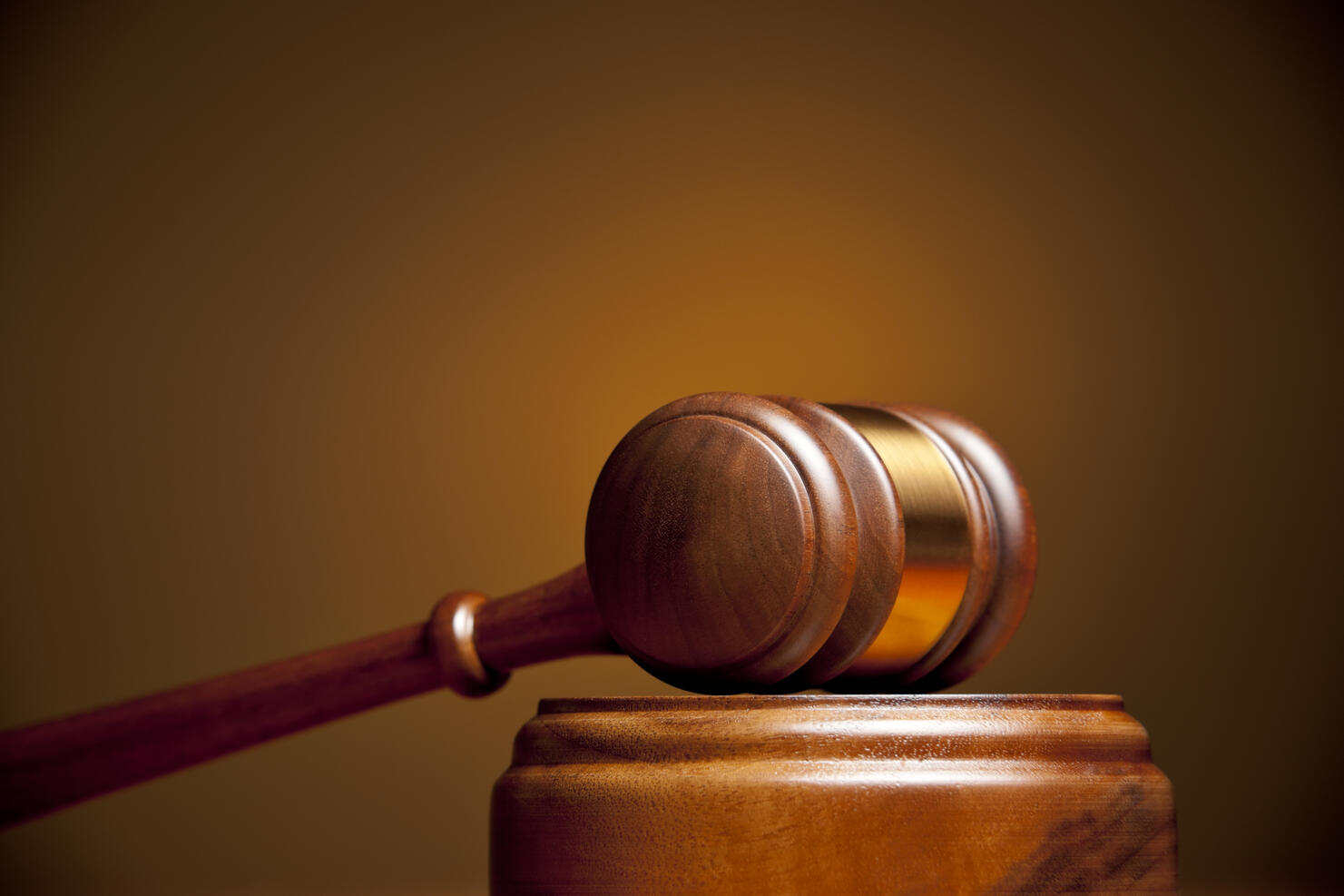Closeup of a gavel resting on a podium