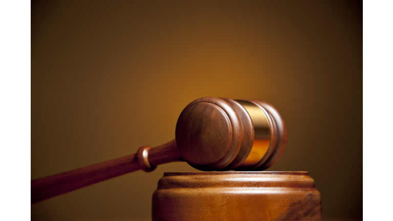 Closeup of a gavel resting on a podium
