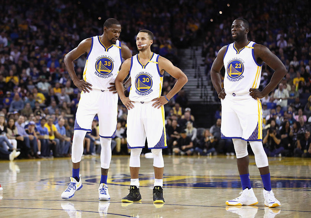 OAKLAND, CA - OCTOBER 04:  Kevin Durant #35, Stephen Curry #30, and Draymond Green #23 of the Golden State Warriors stand on the court during their game against the Los Angeles Clippers during their preseason game at ORACLE Arena on October 4, 2016 in Oakland, California.  NOTE TO USER: User expressly acknowledges and agrees that, by downloading and or using this photograph, User is consenting to the terms and conditions of the Getty Images License Agreement.  (Photo by Ezra Shaw/Getty Images)