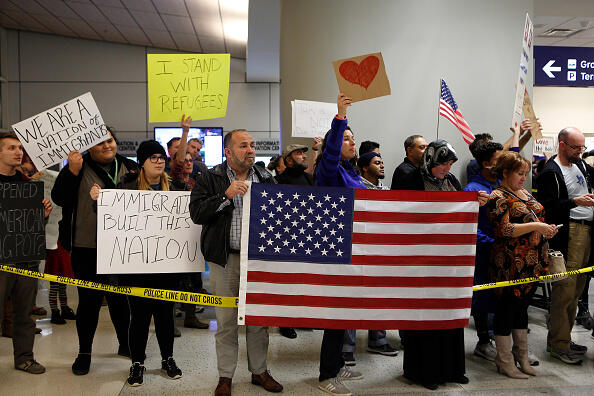DALLAS, TX - JANUARY 28: Protesters gather to denounce President Donald Trump's executive order that bans certain immigration, at Dallas-Fort Worth International Airport on January 28, 2017 in Dallas, Texas. President Trump signed the controversial executive order that halted refugees and residents from predominantly Muslim countries from entering the United States. (Photo by G. Morty Ortega/Getty Images)