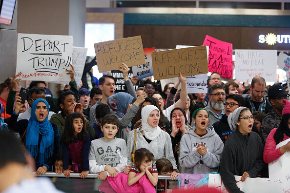 DALLAS, TX - JANUARY 28: Protesters gather to denounce President Donald Trump's executive order that bans certain immigration, at Dallas-Fort Worth International Airport on January 28, 2017 in Dallas, Texas. President Trump signed the controversial executive order that halted refugees and residents from predominantly Muslim countries from entering the United States. (Photo by G. Morty Ortega/Getty Images)