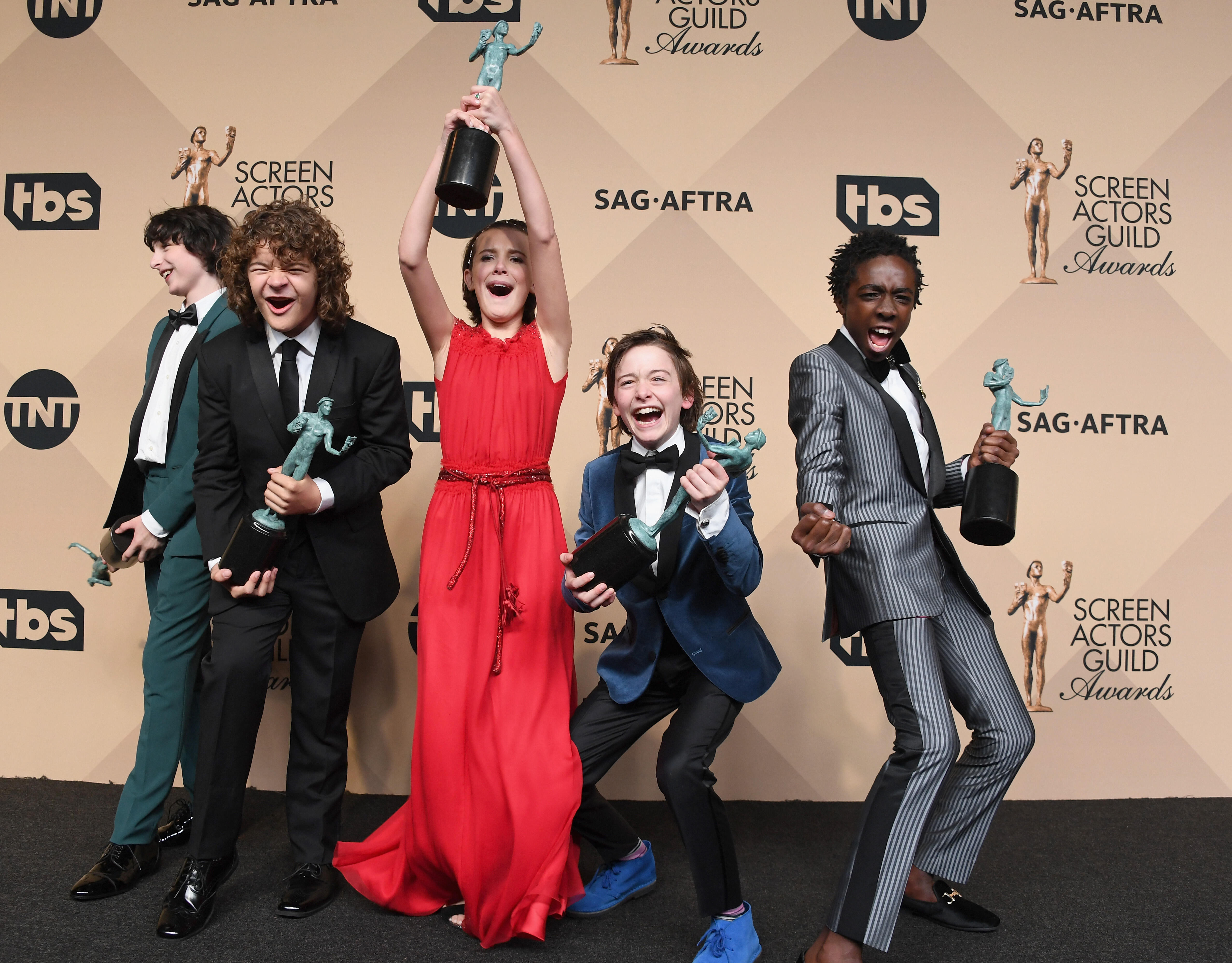 LOS ANGELES, CA - JANUARY 29:  (L-R) Actors Finn Wolfhard, Gaten Matarazzo, Millie Bobby Brown, Noah Schnapp, and Caleb McLaughlin co-recipients of the Outstanding Performance by an Ensemble in a Drama Series award for 'Stranger Things,' pose in the press