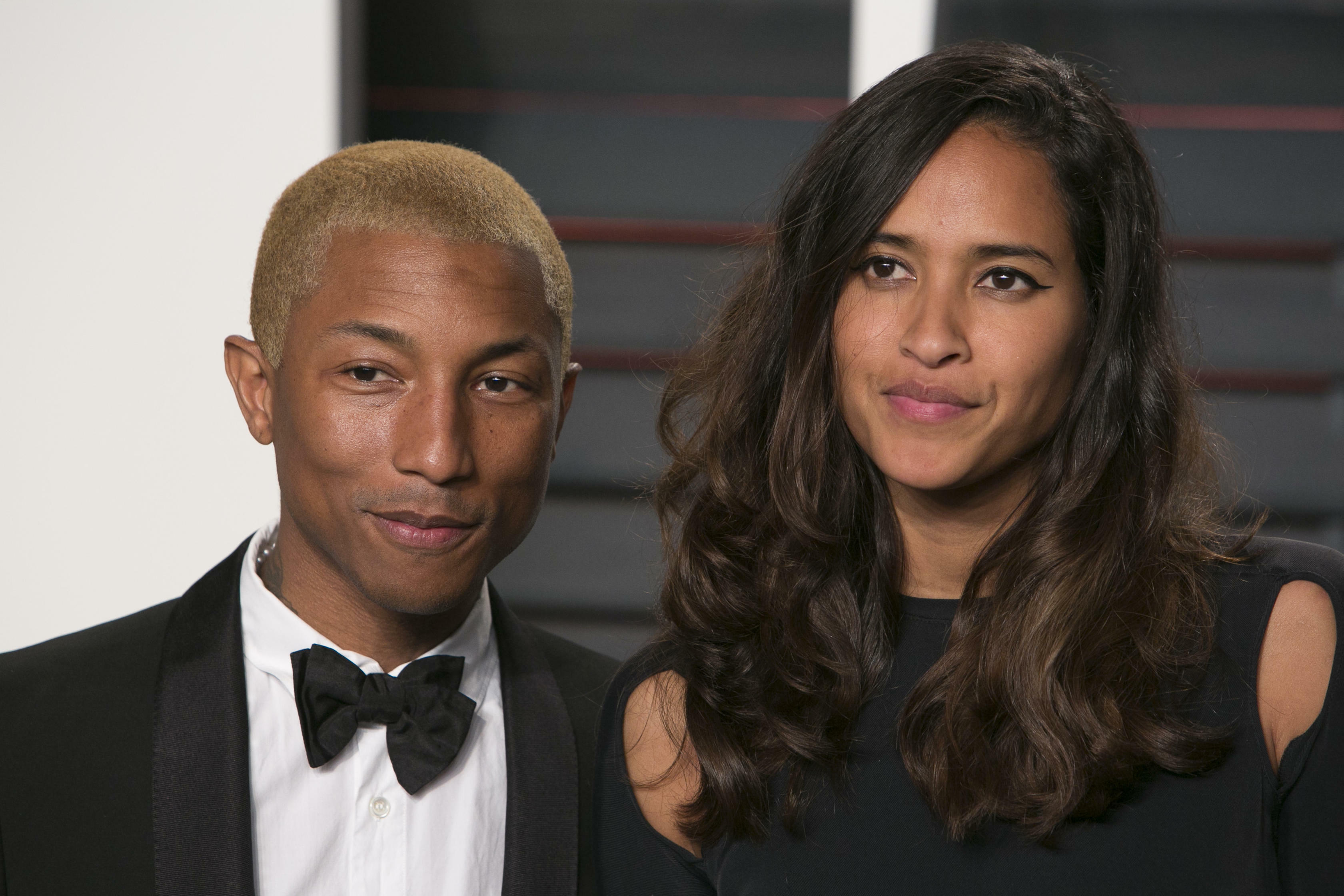 US musician Pharrell Williams and his wife Helen Lasichanh arrive to the 2016 Vanity Fair Oscar Party in Beverly Hills, California on February 28, 2016. / AFP / ADRIAN SANCHEZ-GONZALEZ        (Photo credit should read ADRIAN SANCHEZ-GONZALEZ/AFP/Getty Ima