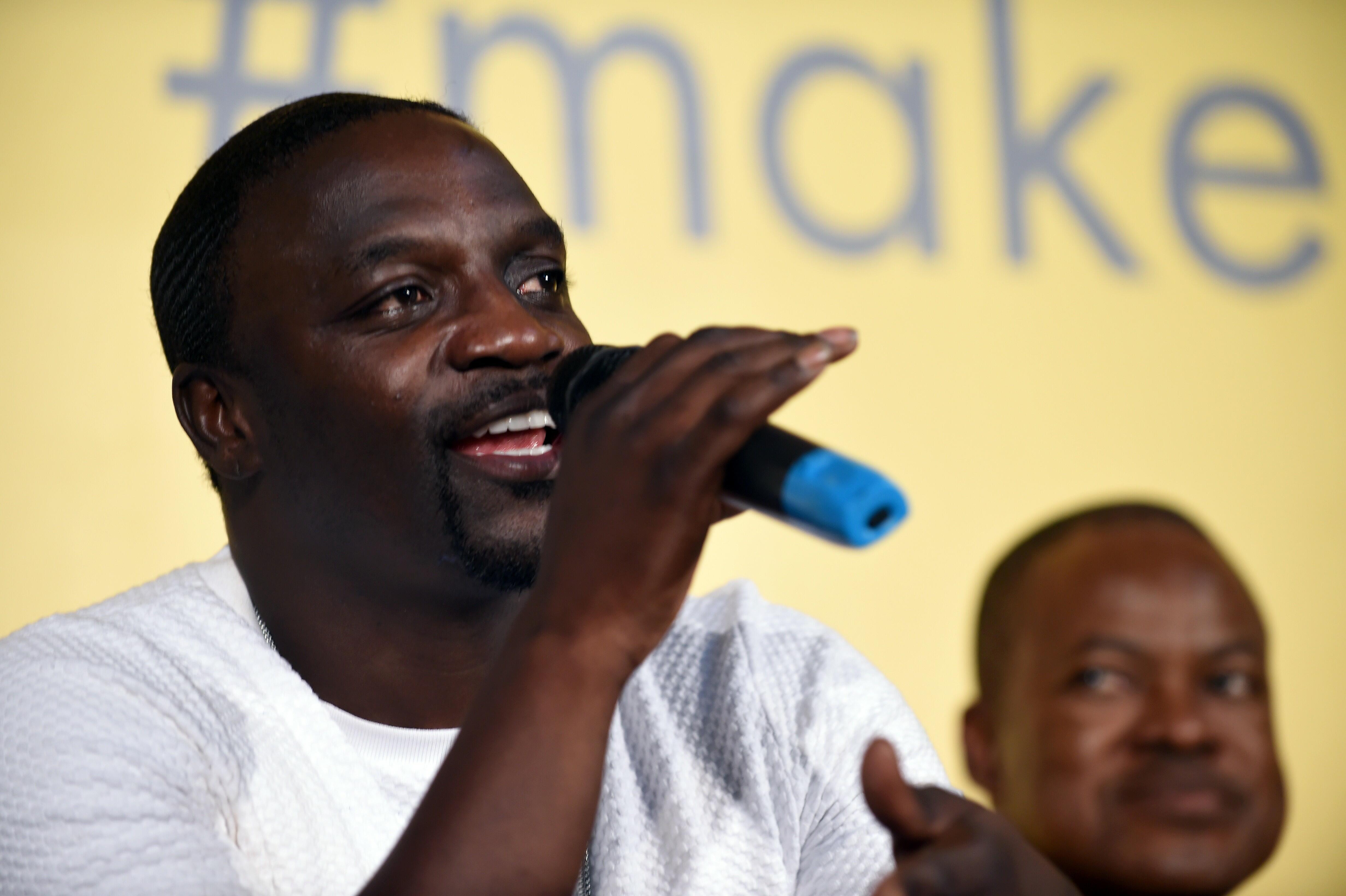 Rapper and songwriter Akon speaks during the unveiling ceremony of the Africa's first kinetic football pitch in Lagos, on December 10, 2015. The pitch combines solar energy with innovative technology  that harnesses the energy of player's movement and con