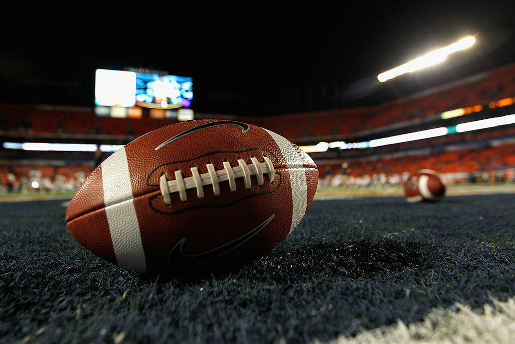 MIAMI GARDENS, FL - JANUARY 04:  A detail of a Nike official NCAA size football as it sits in the end zone while the West Virginia Mountaineers stretchon the field prior to playing against the Clemson Tigers during the Discover Orange Bowl at Sun Life Sta