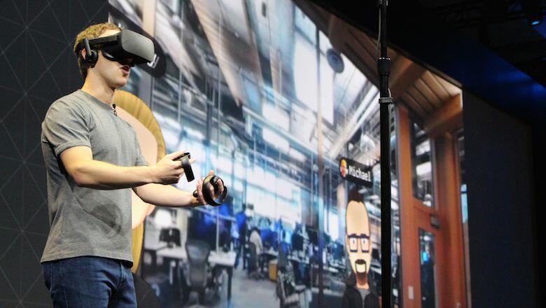 Facebook co-founder and chief executive, Mark Zuckerberg, speaks at an Oculus developers conference while wearing a virtual reality headset in San Jose, California on October 6, 2016.  Facebook unveiled new hardware for its Oculus division as part of a st