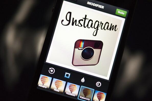 The Instagram logo is displayed on a smartphone on December 20, 2012 in Paris. Instagram backed down on December 18, 2012 from a planned policy change that appeared to clear the way for the mobile photo sharing service to sell pictures without compensatio