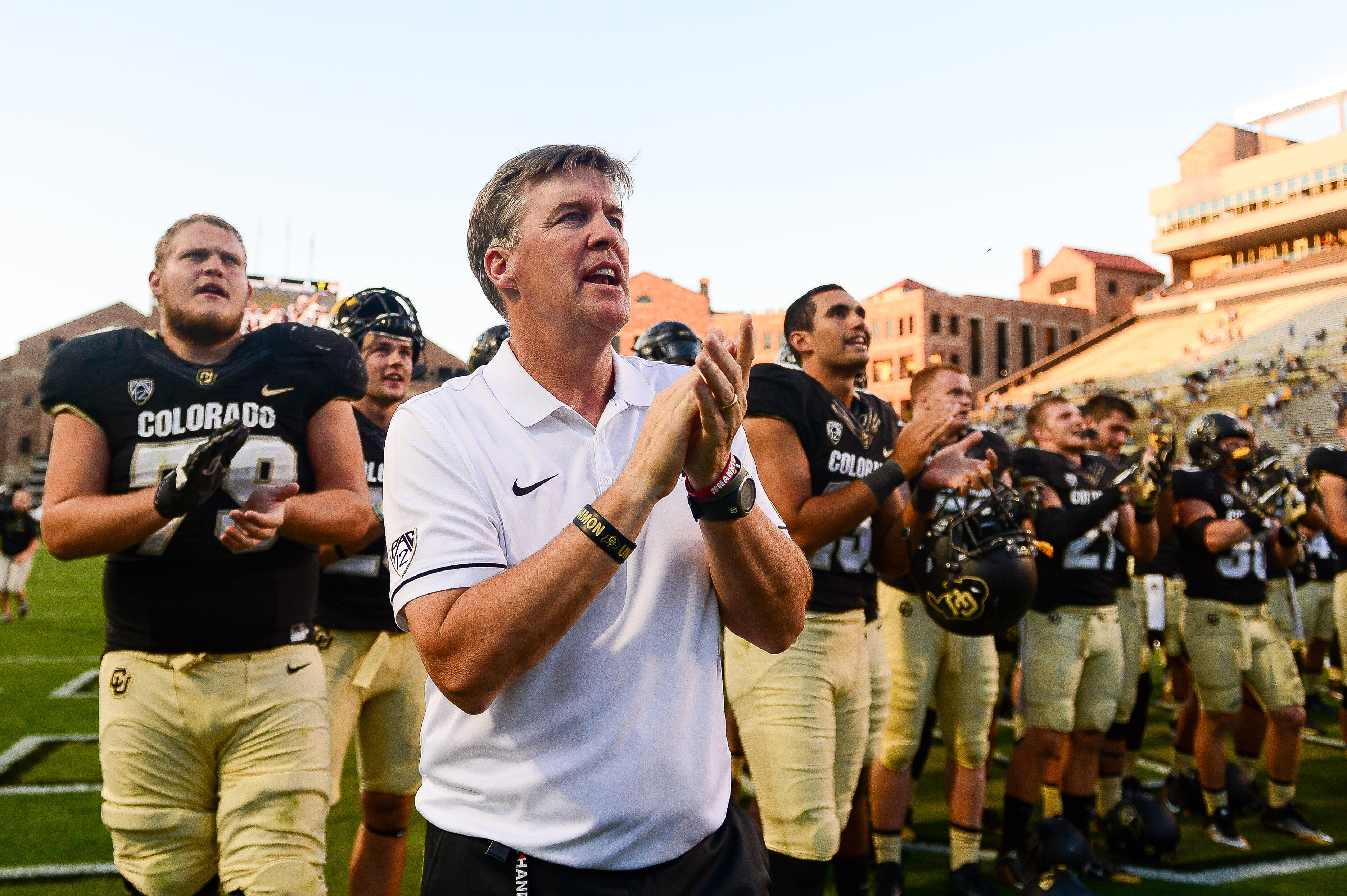 BOULDER, CO - SEPTEMBER 10:  Head Coach Mike MacIntyre of the Colorado Buffaloes sings along with the band and his team after a 56-7 win over the Idaho State Bengals at Folsom Field on September 10, 2016 in Boulder, Colorado.  (Photo by Dustin Bradford/Ge