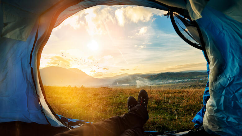 personal perspective of hiker in his tent resting, looking at the sunset and taking a break.