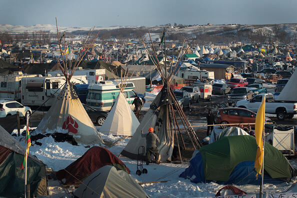 CANNON BALL, ND - DECEMBER 03:  Hawk Laughing, a Mohawk originally from northern New York, helps to build a tipi at Oceti Sakowin Camp on the edge of the Standing Rock Sioux Reservation on December 3, 2016 outside Cannon Ball, North Dakota. Native Americans and activists from around the country have been gathering at the camp for several months trying to halt the construction of the Dakota Access Pipeline. The proposed 1,172-mile-long pipeline would transport oil from the North Dakota Bakken region through South Dakota, Iowa and into Illinois.  (Photo by Scott Olson/Getty Images)