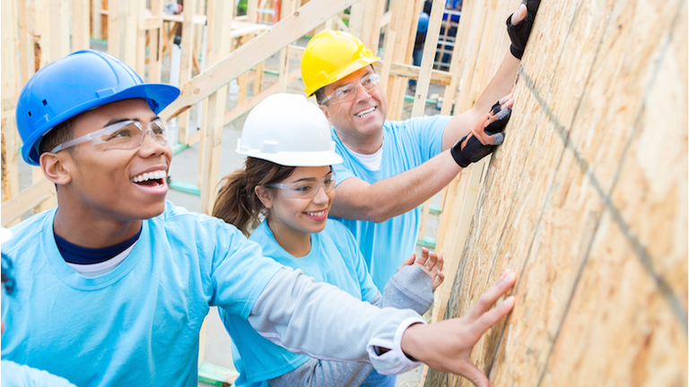 Confident volunteers build wall in charity home