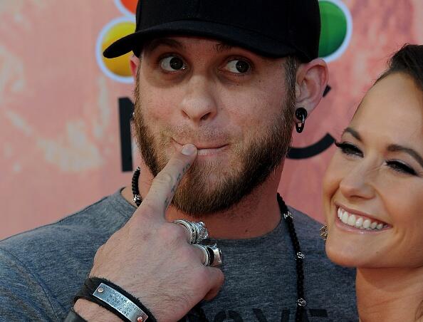 Musician Brantley Gilbert and Amber Cochran arrive on the red carpet during the iHeartRadio Music Awards held at the Shrine Auditorium in Los Angeles, California on March 29,2015.  AFP PHOTO/ VALERIE MACON        (Photo credit should read VALERIE MACON/AFP/Getty Images)