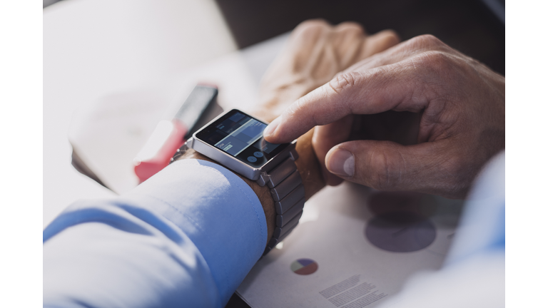 Businessman using smartwatch.