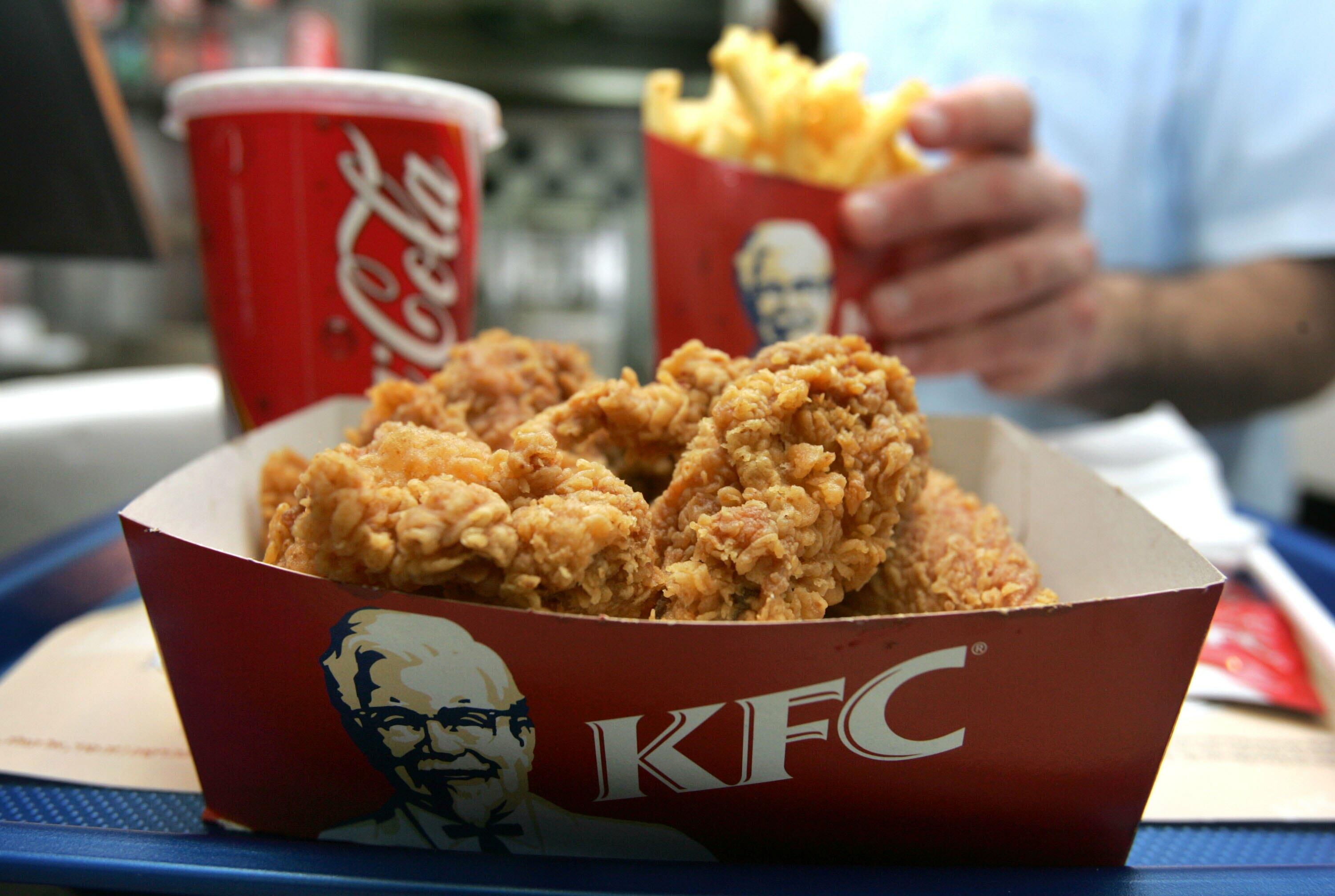 TEL AVIV, ISRAEL - FEBRUARY 17: An employee serves a portion of Kentucky Fried Chicken and chips at the international chain's local franchise February 17, 2006 in Tel Aviv, Israel. Officials are trying to reassure consumers that it is safe to eat well coo