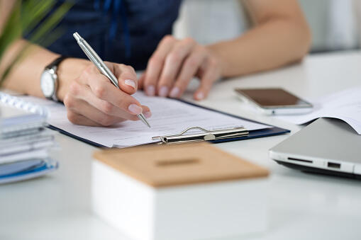 Woman writing something  sitting at her office