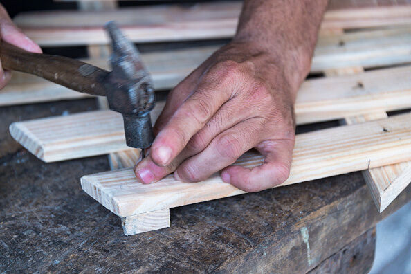 Hardworking carpenter: Blue collar Cuban carpenter hammering
