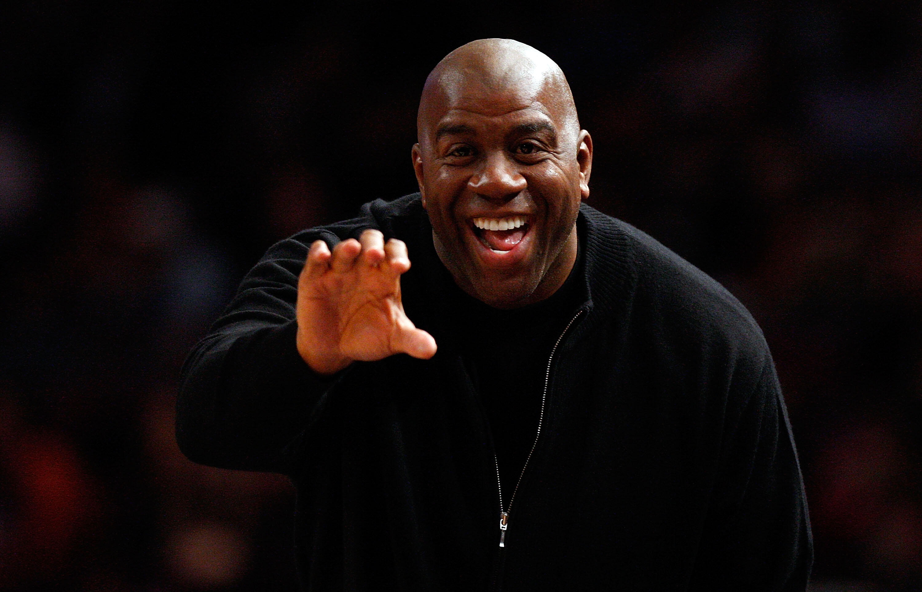 NEW YORK - NOVEMBER 16:  NBA legend, Magic Johnson waves on the sideline during the game between the Dallas Mavericks and the New York Knicks on November 16, 2008 at Madison Square Garden in New York City. NOTE TO USER: User expressly acknowledges and agr