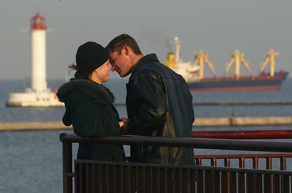 ODESSA, UKRAINE - DECEMBER 8: A couple share a romantic moment, December 8, 2004 overlooking the Ukranian port city of Odessa.  Situated at the crossroads of several of the world's major trading routes, Odessa is central to the economy of  Ukraine.    (Ph