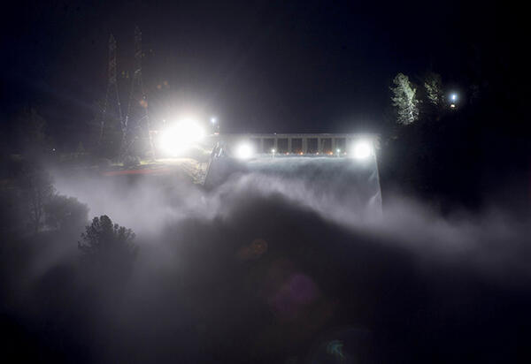 This long exposure photograph shows the Oroville Dam discharging water at a rate of 100,000 cubic feet per second over a spillway as an emergency measure in Oroville, California on February, 2017. More than 100,000 people have been evacuated 