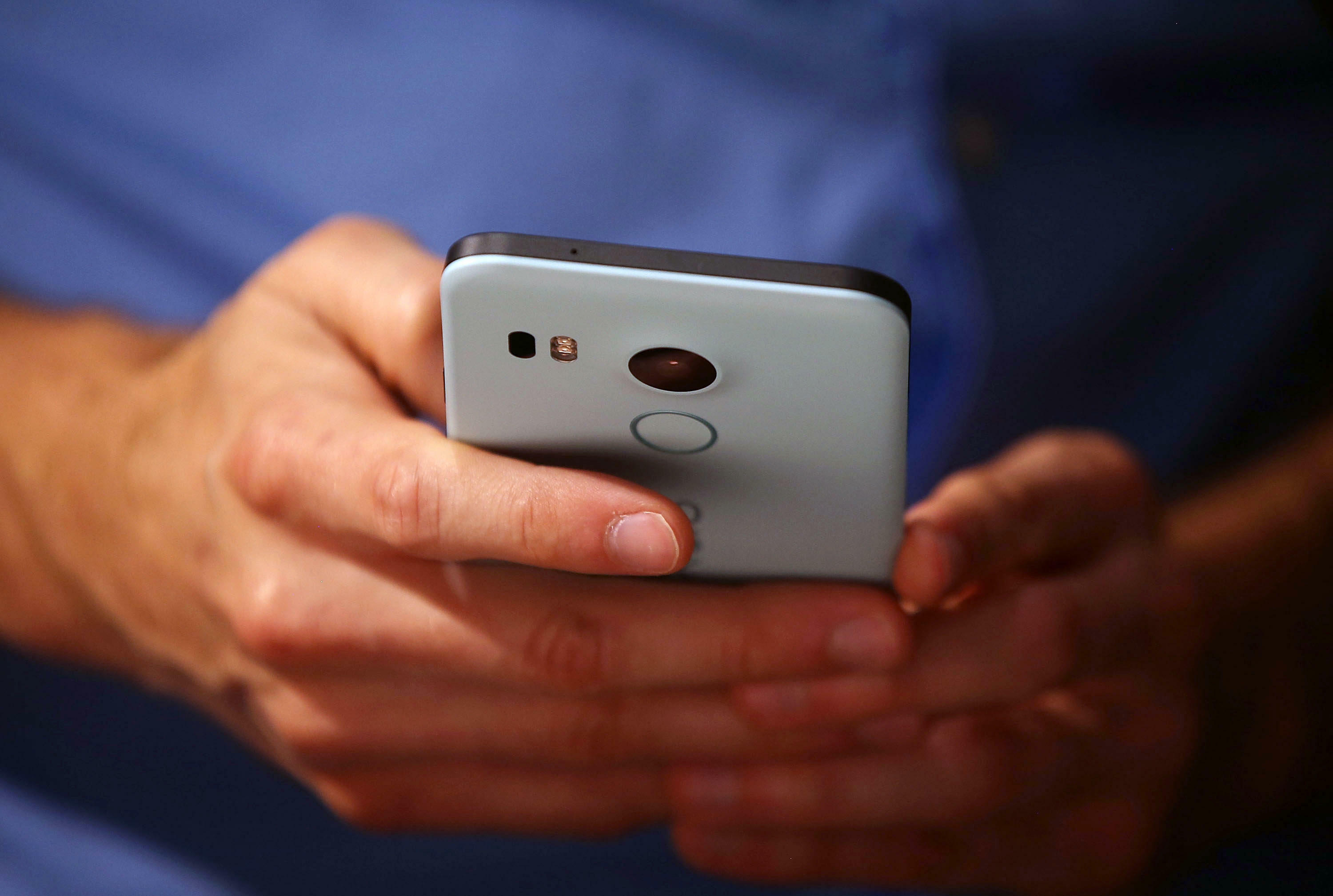 SAN FRANCISCO, CA - SEPTEMBER 29:  An attendee inspects the new Nexus 5X phone during a Google media event on September 29, 2015 in San Francisco, California. Google unveiled its 2015 smartphone lineup, the Nexus 5x and Nexus 6P, the new Chromecast and ne