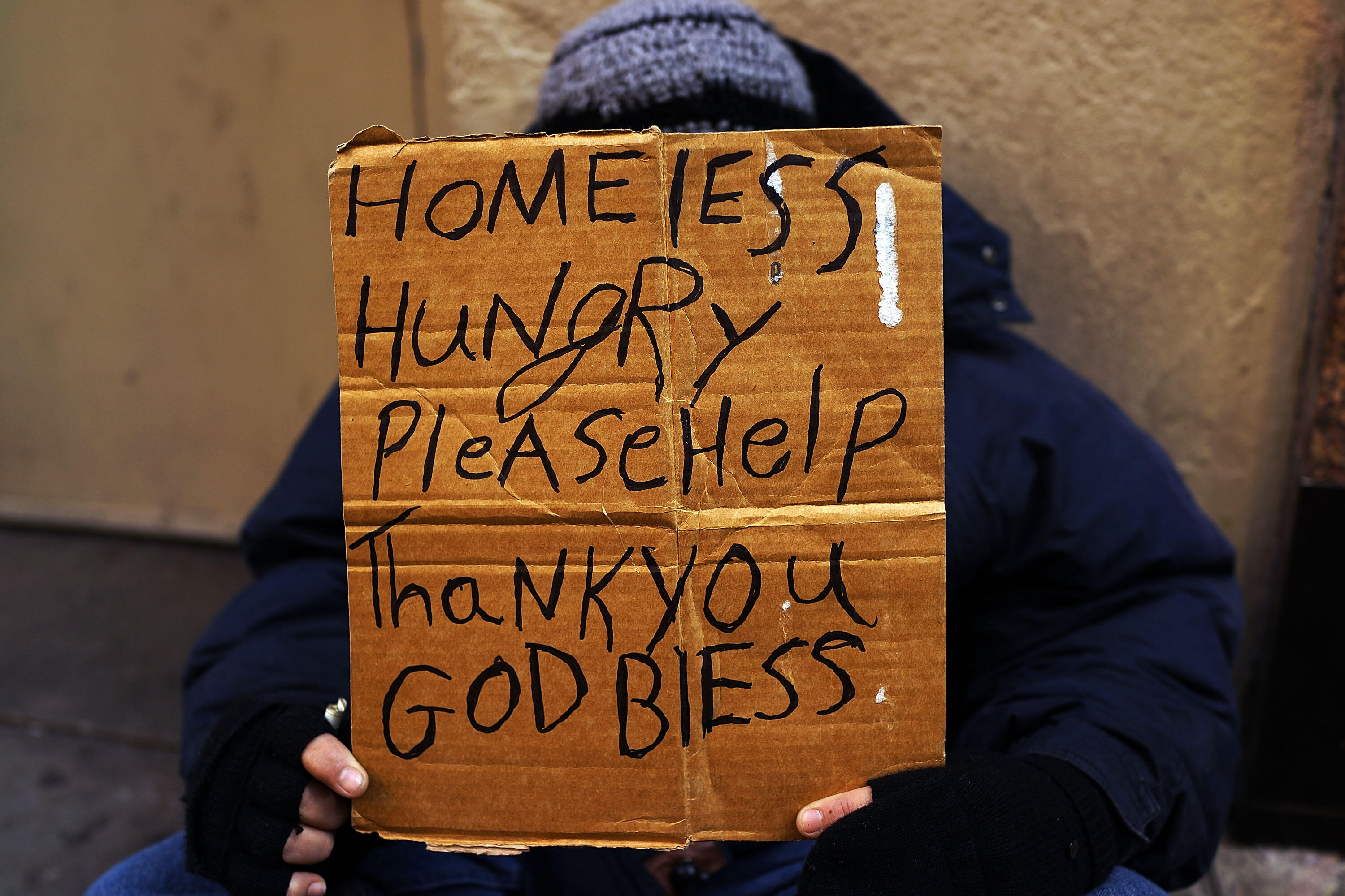 NEW YORK, NY - DECEMBER 04:  A person in economic difficulty holds a homemade sign asking for money along a Manhattan street on December 4, 2013 in New York City.  According to a recent study by the by the United States Department of Housing and Urban Dev