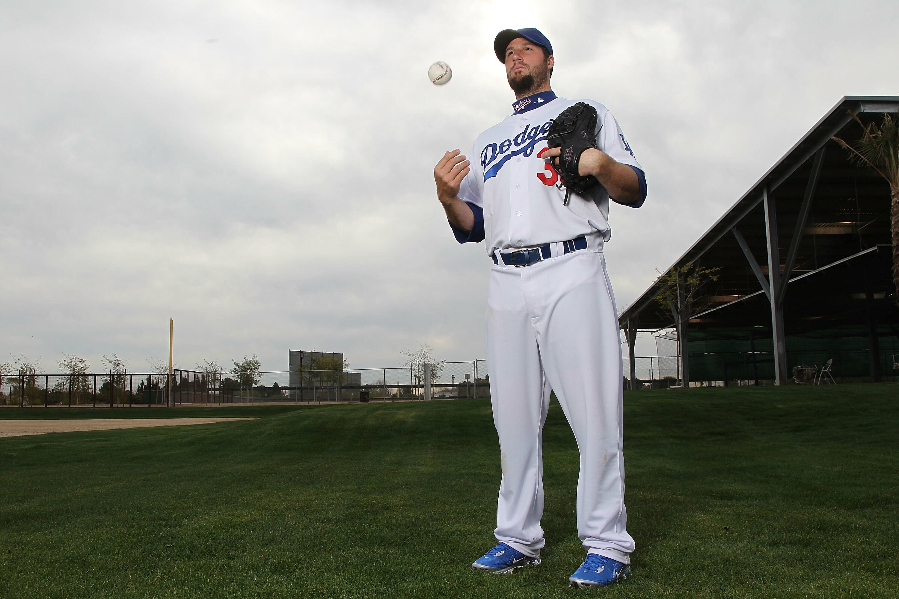 Former Dodger pitcher Eric Gagne walks from the field before an News  Photo - Getty Images