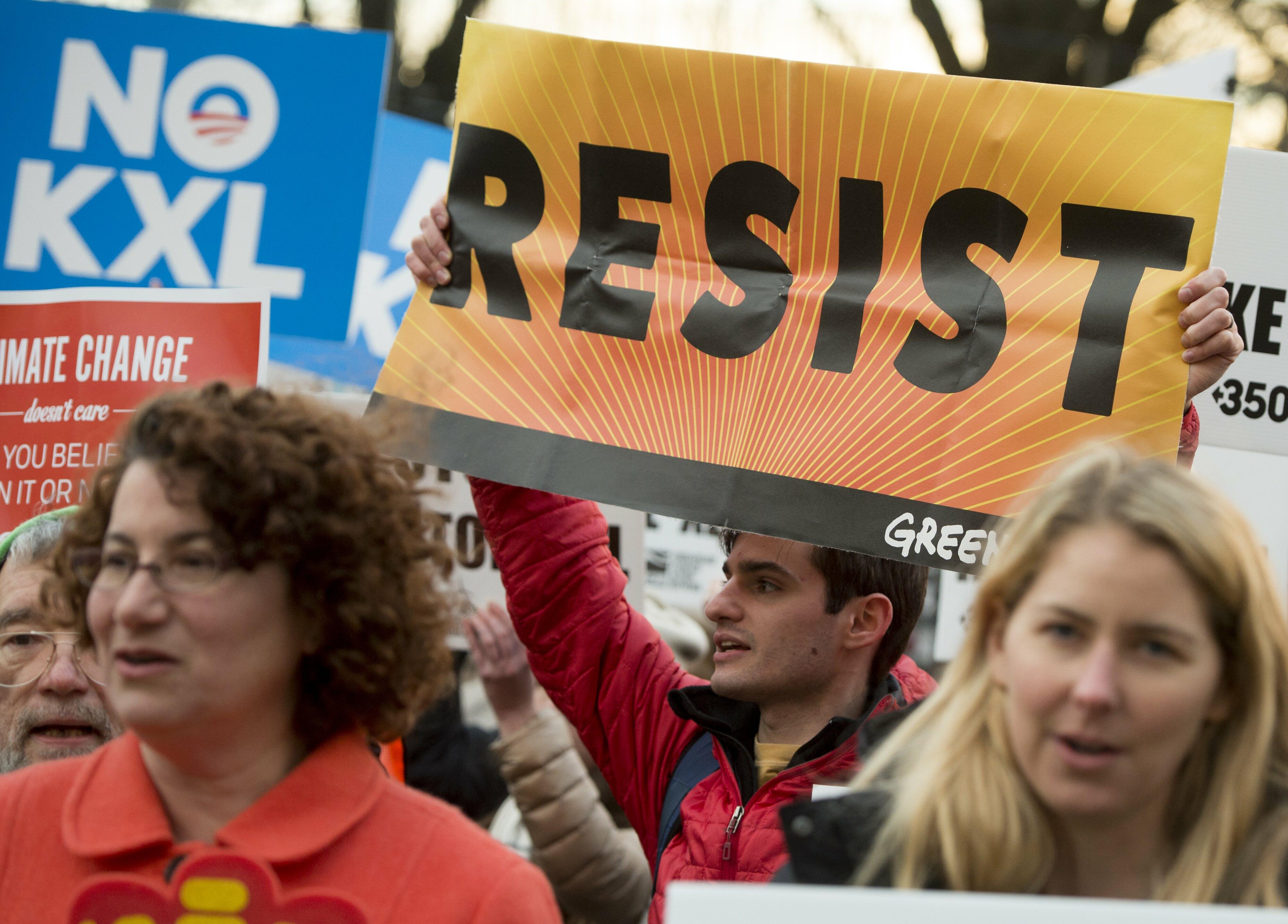 Opponents of the Keystone XL and Dakota Access pipelines hold a rally as they protest US President Donald Trump's executive orders advancing their construction, at Lafayette Park next to the White House in Washington, DC, on January 24, 2017. US President