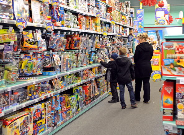 A mother and her sons walk past the shelves of La Grande Recre toys departement store in the French northern city of Bruay-la-Buissiere on November 20, 2010. As Christmas time comes closer, French consumers start their shopping season and purchase toys. A