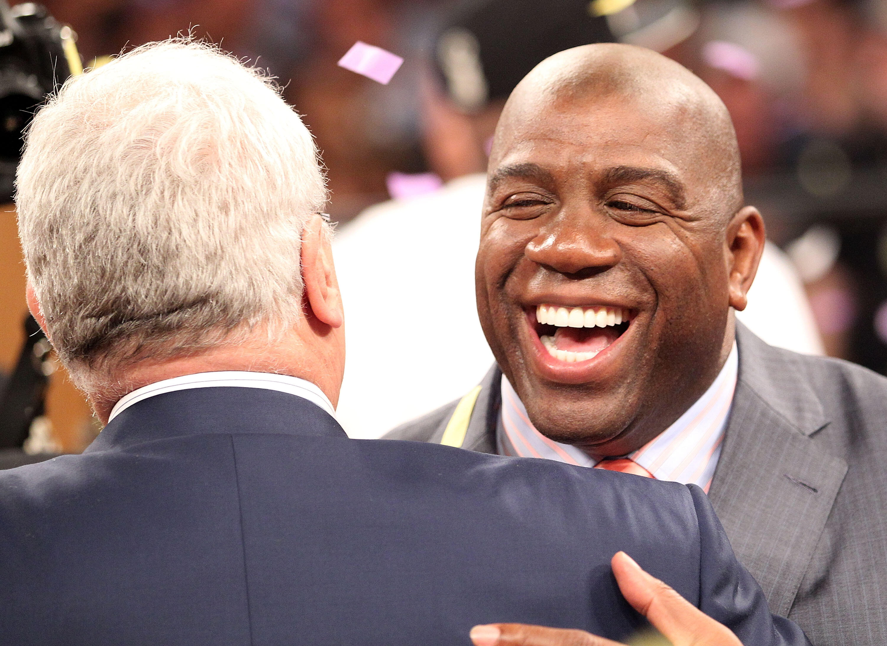 LOS ANGELES, CA - JUNE 17:  Earvin 'Magic' Johnson hugs general manager Mitch Kupchak after the Los Angeles Lakers defeated the Boston Celtics in Game Seven of the 2010 NBA Finals at Staples Center on June 17, 2010 in Los Angeles, California.  NOTE TO USE