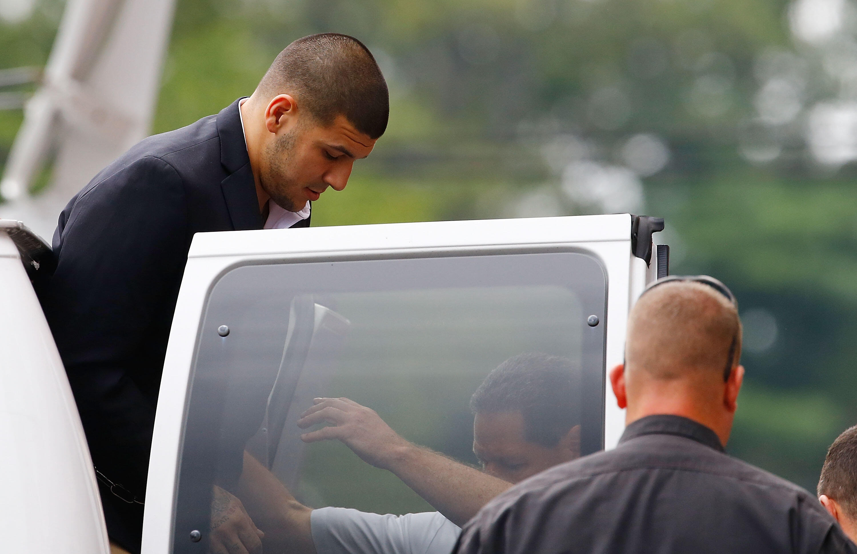 NORTH ATTLEBORO, MA - AUGUST 22: Aaron Hernandez is escorted into Attleboro District Court prior to his hearing on August 22, 2013 in North Attleboro, Massachusetts. Former New England Patriot Aaron Hernandez has been indicted on a first-degree murder cha