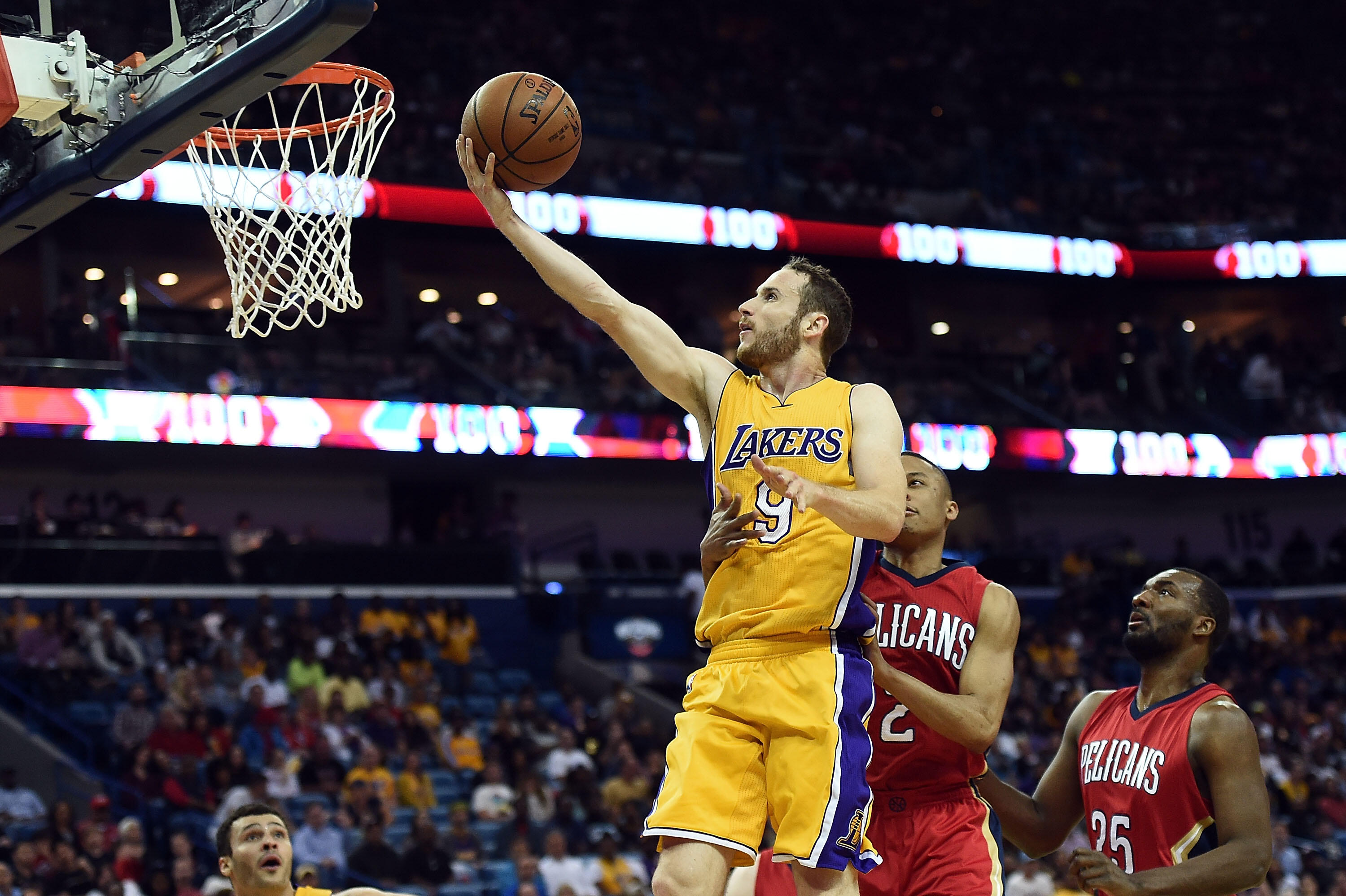 NEW ORLEANS, LA - APRIL 08: Marcelo Huertas #9 of the Los Angeles Lakers is fouled by Tim Frazier #2 of the New Orleans Pelicans during the second half of a game at the Smoothie King Center on April 8, 2016 in New Orleans, Louisiana. NOTE TO USER: User ex