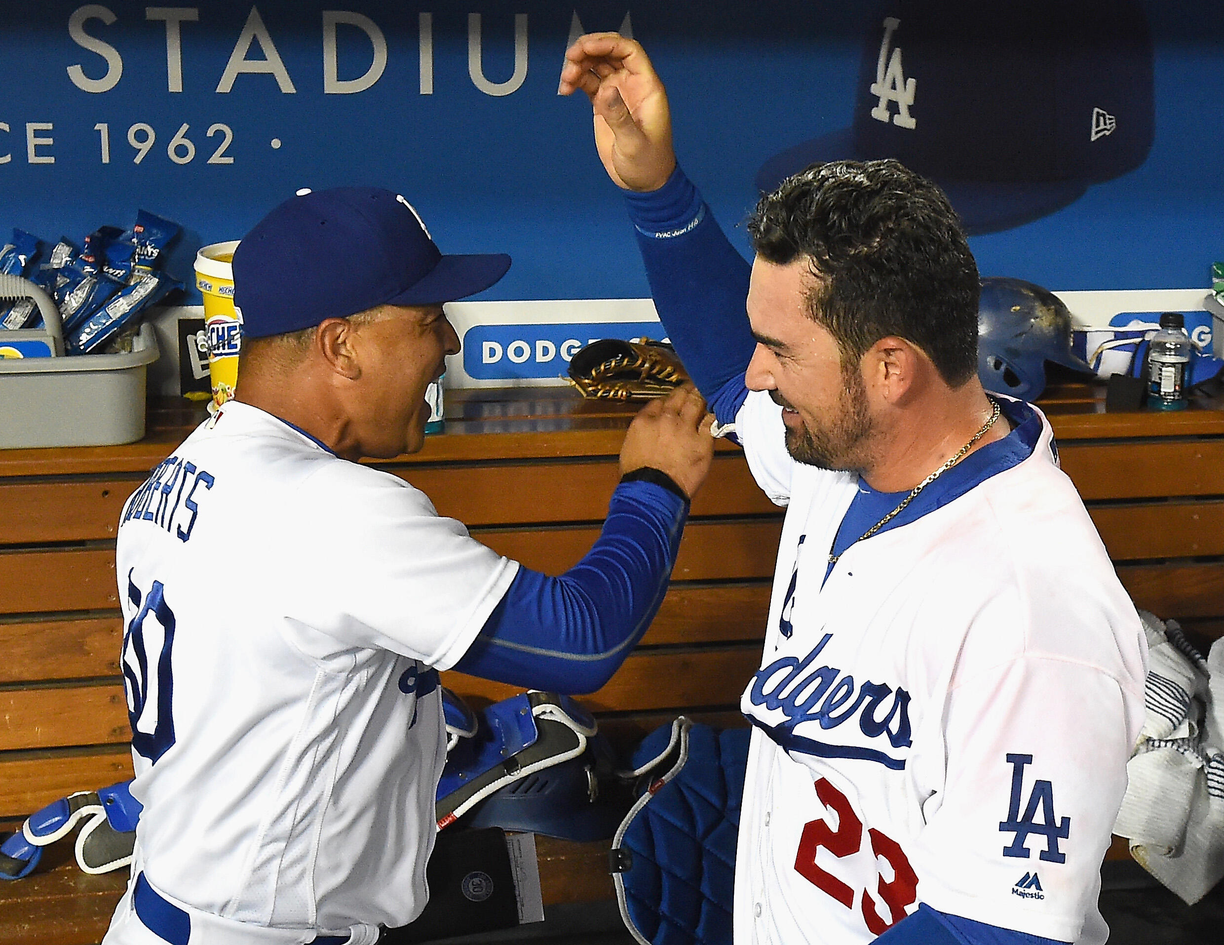 LOS ANGELES, CA - SEPTEMBER 19:  Adrian Gonzalez #23 gets a high five from manager Dave Roberts #30 after he hit a walk off double that scored the winning run in the ninth inning of the game against the San Francisco Giants at Dodger Stadium on September 