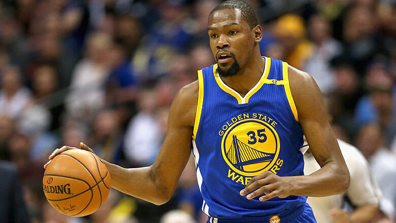 DENVER, CO - FEBRUARY 13: Kevin Durant #35 of the Golden State Warriors brings the ball down court against the Denver Nuggets at the Pepsi Center on February 13, 2017 in Denver, Colorado. NOTE TO USER: User expressly acknowledges and agrees that , by down