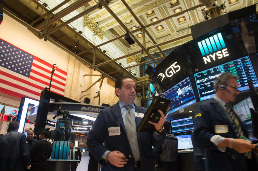 A trader works on the floor before the Dow Jones closing bell at the New York Stock Exchange, February 21, 2017 in New York.  US stocks jumped with retailers and energy firms among the winners as positive sentiment about President Donald Trump's economic 