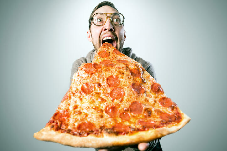 Man Eating Oversized Pizza Slice