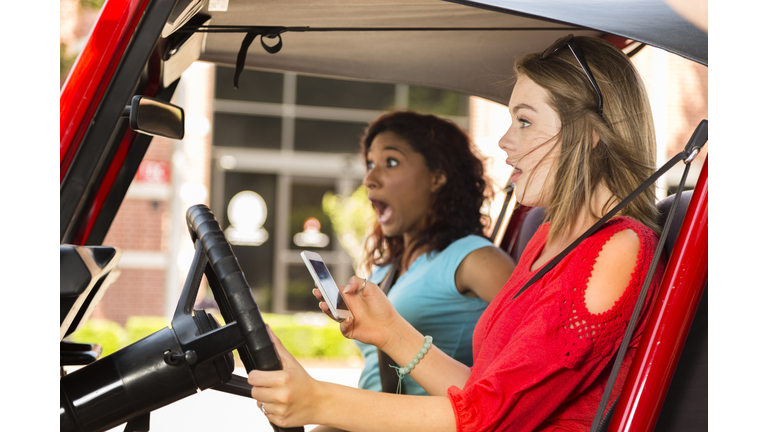 Multi-ethnic teenage girls texting while driving their car. Crash!