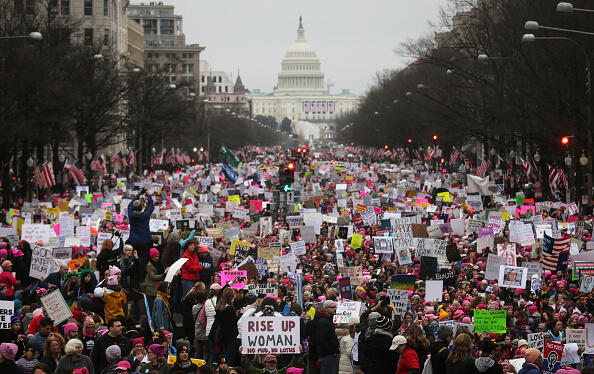 WASHINGTON, DC - JANUARY 21:  Protesters walk during the Women's March on Washington, with the U.S. Capitol in the background, on January 21, 2017 in Washington, DC. Large crowds are attending the anti-Trump rally a day after U.S. President Donald Trump was sworn in as the 45th U.S. president.  (Photo by Mario Tama/Getty Images)